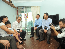Donald Tsang visits a family