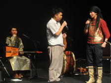 Vocal workout: An ensemble member demonstrates the “khoomi” throat-singing technique, singing two notes at the same time, and invites an audience member to give it a try.
