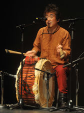 Feel the rhythm: Baoyin plays a compact drum set - a goat-skin mounted drum with a wooden block and tambourine.