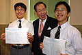 Arthur Li congratulates two St Joseph's boys who scored 10 As