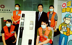 Permanent Secretary for Housing, Planning and Lands, Mr Leung Chin-man, (centre) pictures with a group of "drainage ambassadors".