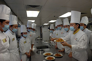 教導員評審學員烹調的咕嚕雞柳